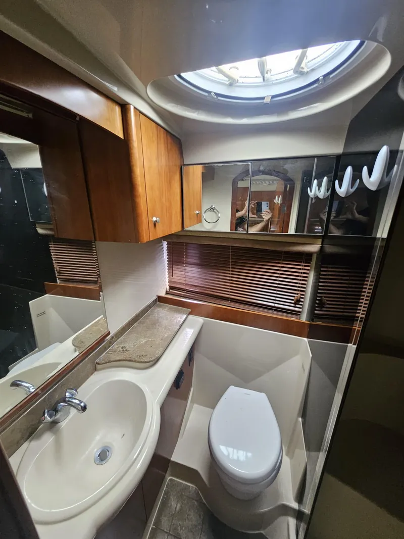 Slide: The Image of Luxurious bathroom in 2008 Cruisers Yachts 390 Sports Coupe with sink, toilet, and wood accents. - 13