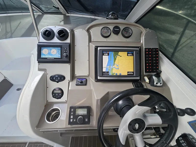 Slide: The Image of 2008 Cruisers Yachts 390 Sports Coupe helm with navigation screens and controls. - 9