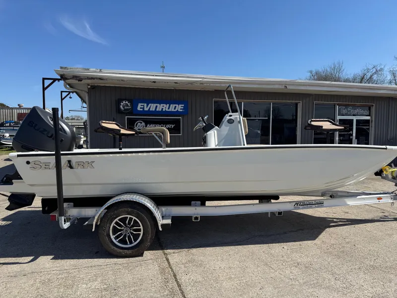 The Image of 2025 SeaArk Bay Runner 190 boat on trailer, parked outside dealership. - 1