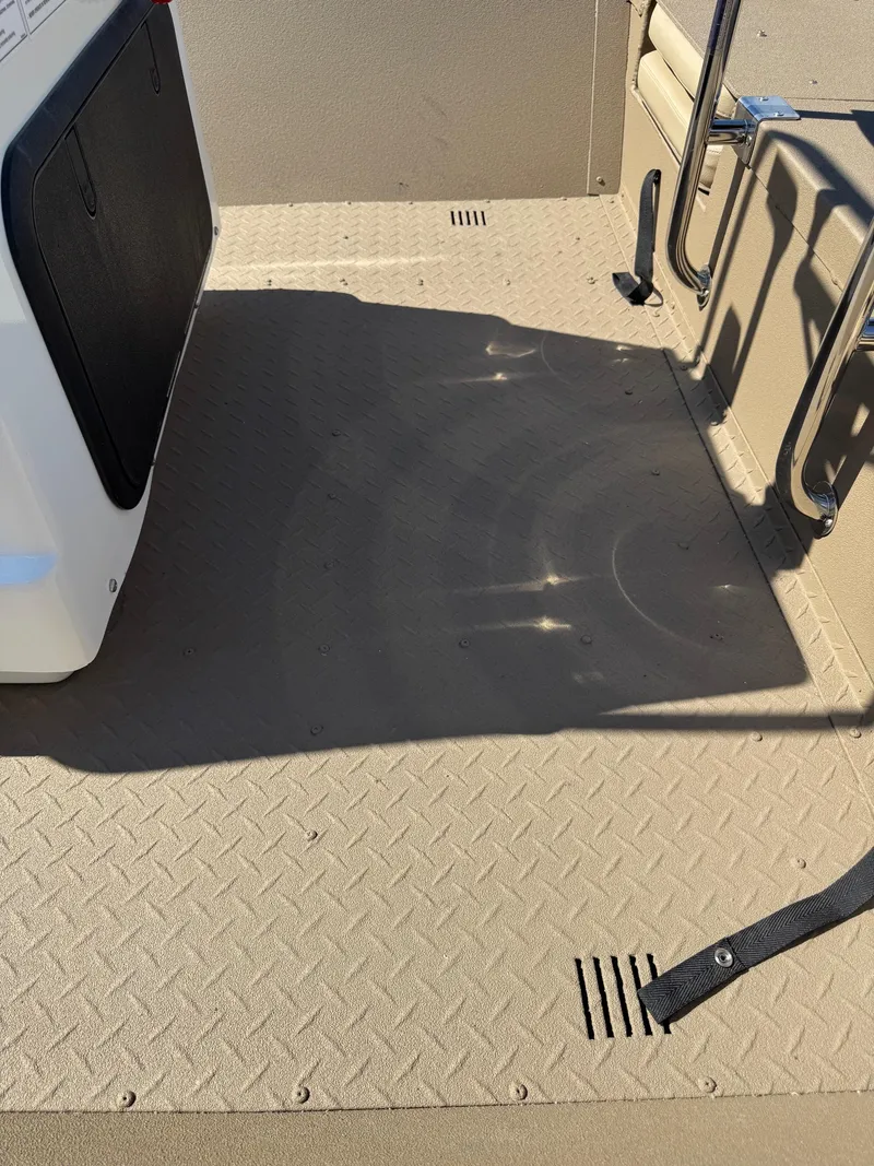 Slide: The Image of 2025 SeaArk Bay Runner 190 boat interior with textured flooring and seating area. - 12