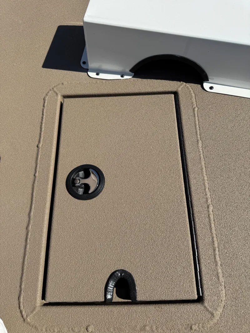 Slide: The Image of 2025 SeaArk Bay Runner 190 deck hatch with textured surface and latch. - 7