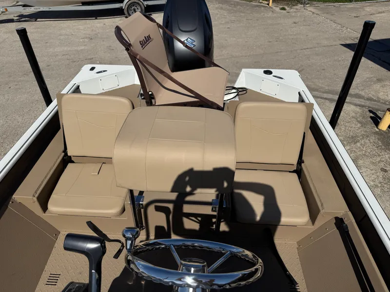 Slide: The Image of 2025 SeaArk Bay Runner 190 boat interior with beige seating and steering wheel. - 8
