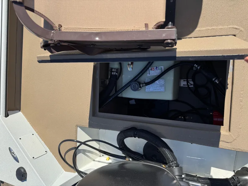 Slide: The Image of 2025 SeaArk Bay Runner 190 boat compartment with wiring and battery. - 9