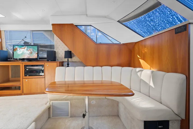 Slide: The Image of Interior of 2000 Silverton 392 Motor Yacht with cozy seating and entertainment area. - 12
