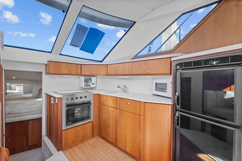 Slide: The Image of Interior of 2000 Silverton 392 Motor Yacht with modern kitchen amenities. - 14