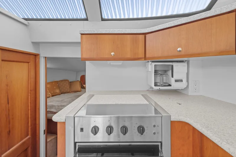 Slide: The Image of Interior of 2000 Silverton 392 Motor Yacht kitchen with stove and cabinets. - 15