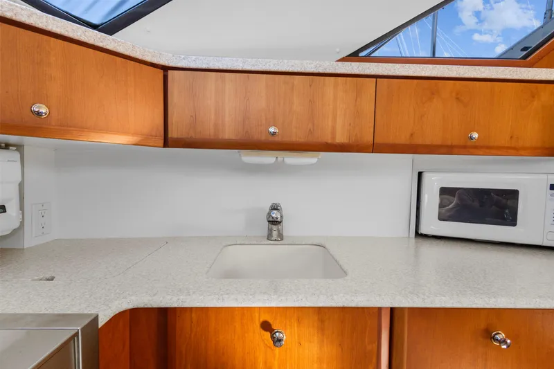 Slide: The Image of Interior of 2000 Silverton 392 Motor Yacht kitchen with sink and microwave. - 17