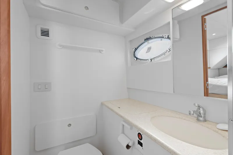 Slide: The Image of Luxurious bedroom interior of 2000 Silverton 392 Motor Yacht with cozy bed and wooden cabinetry. - 18