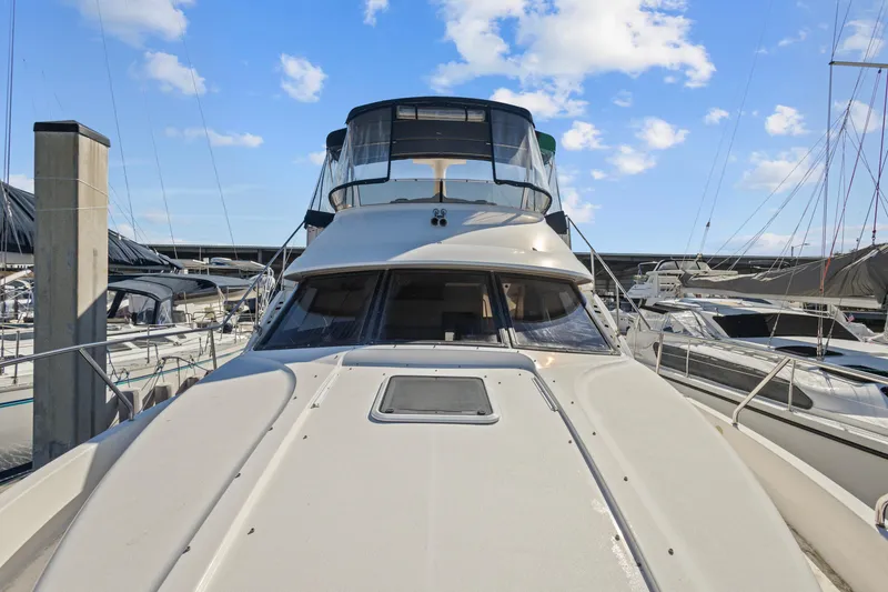 Slide: The Image of 2000 Silverton 392 Motor Yacht docked at marina under blue sky. - 2