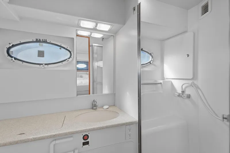 Slide: The Image of Bathroom interior of 2000 Silverton 392 Motor Yacht with sink and porthole window. - 20