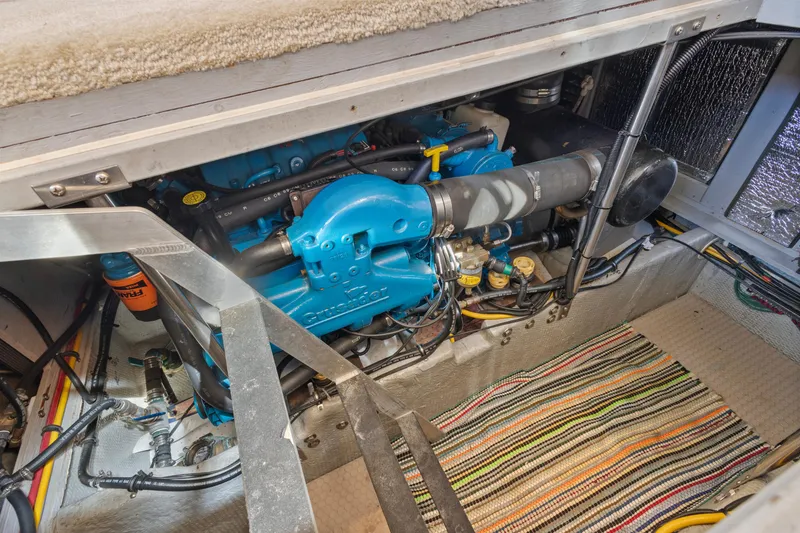 Slide: The Image of Engine compartment of a 2000 Silverton 392 Motor Yacht, featuring a blue engine. - 27