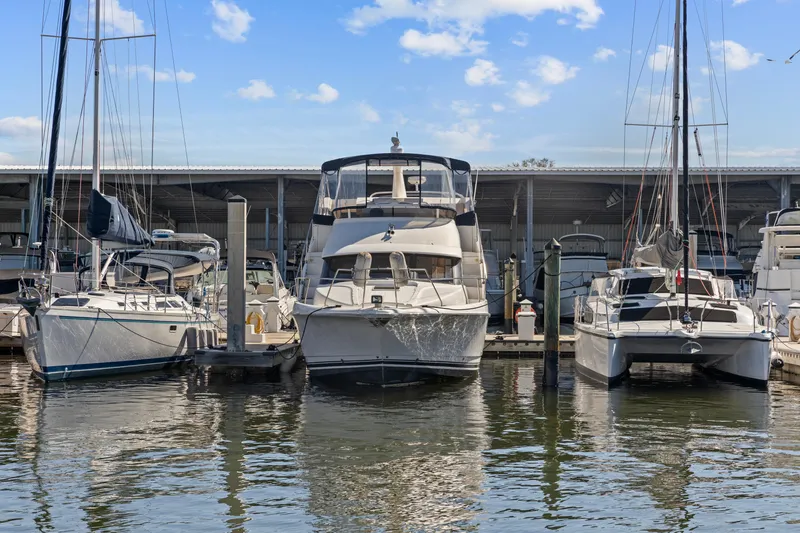 Slide: The Image of 2000 Silverton 392 Motor Yacht docked at marina under blue sky. - 3