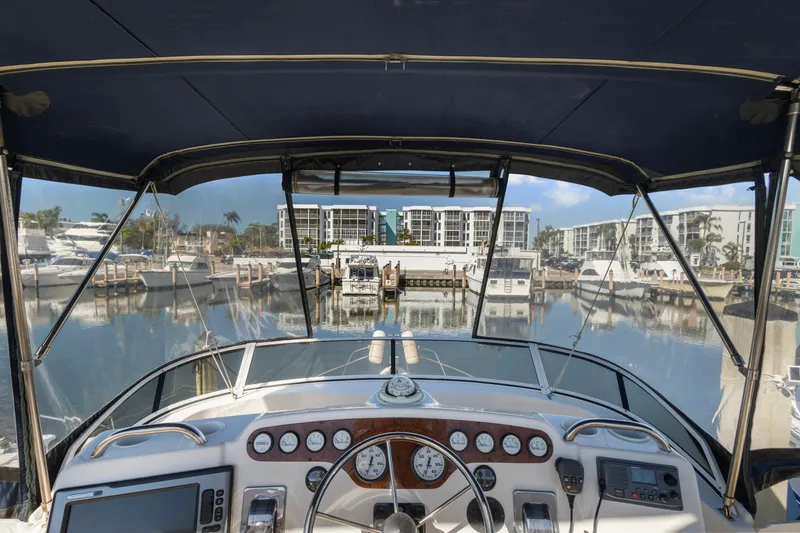 Slide: The Image of Cockpit view of 2000 Silverton 392 Motor Yacht docked in a marina. - 4