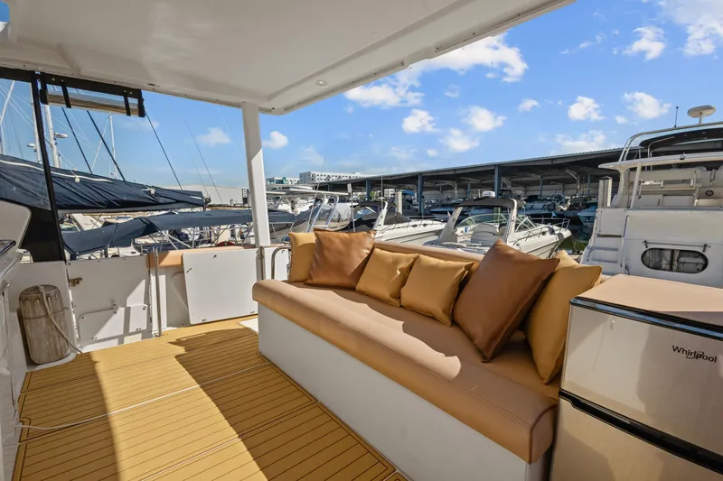 Slide: The Image of 2000 Silverton 392 Motor Yacht with cushioned seating, docked at marina under blue sky. - 8