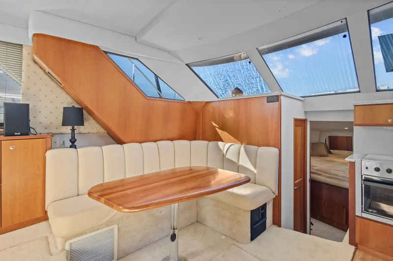 Slide: The Image of 2000 Silverton 392 Motor Yacht interior with dining area and modern amenities. - 9