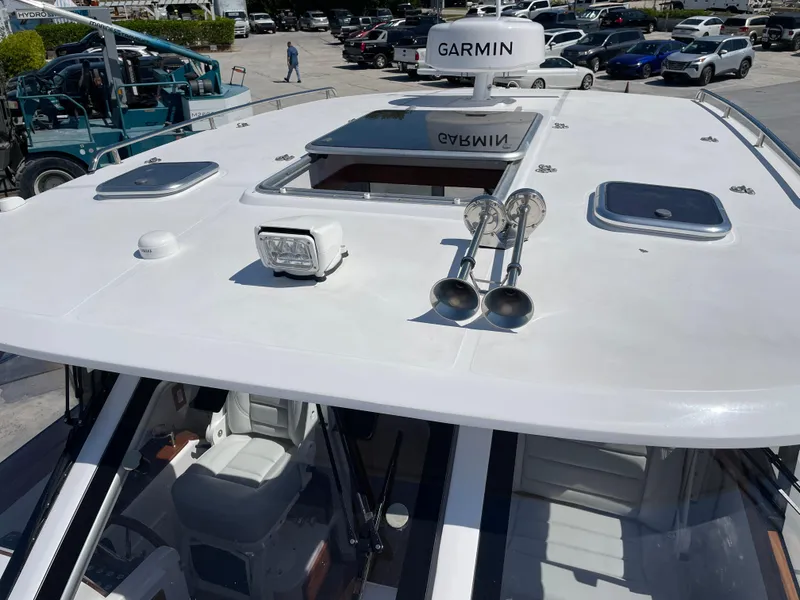 Slide: The Image of 2025 True North 34 Outboard Express boat with Garmin radar and rooftop features. - 11