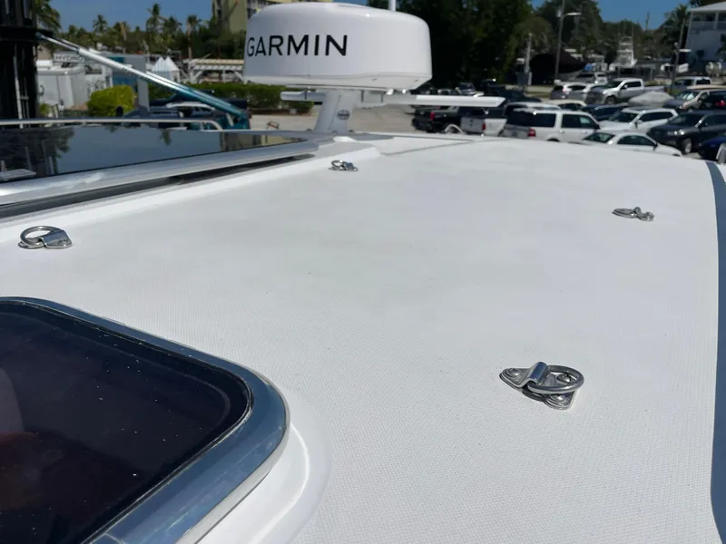 Slide: The Image of True North 34 Outboard Express 2025 boat deck with Garmin radar in marina setting. - 12