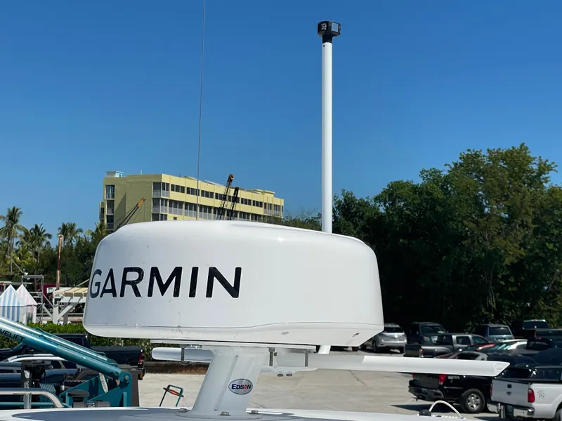 Slide: The Image of Garmin radar on 2025 True North 34 Outboard Express boat, clear blue sky background. - 13