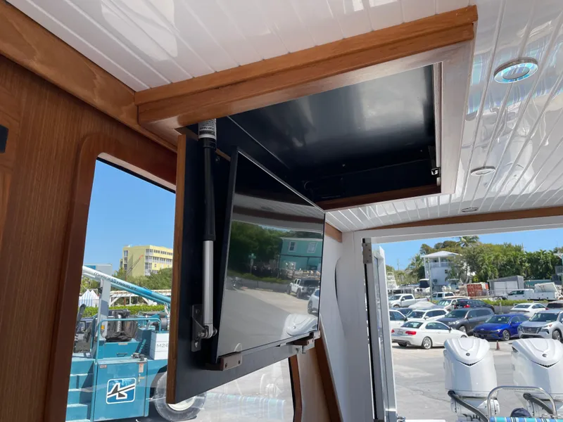 Slide: The Image of Interior view of 2025 True North 34 Outboard Express with retractable TV. - 23