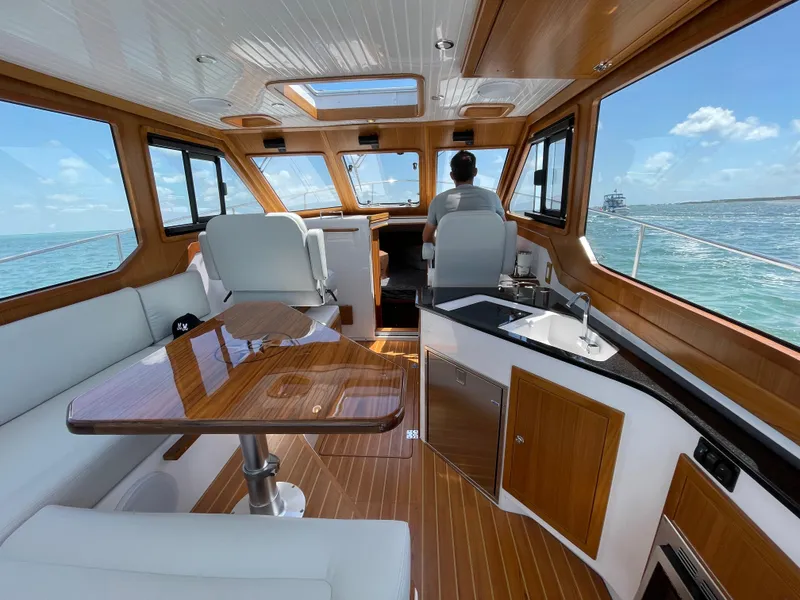 Slide: The Image of Interior of 2025 True North 34 Outboard Express boat with modern seating and ocean view. - 26