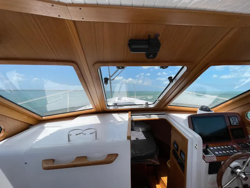 Slide: The Image of Interior view of 2025 True North 34 Outboard Express boat with ocean in background. - 27