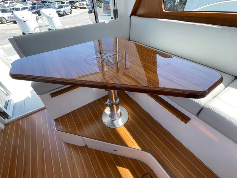 Slide: The Image of Luxurious interior of 2025 True North 34 Outboard Express with polished wooden table. - 28
