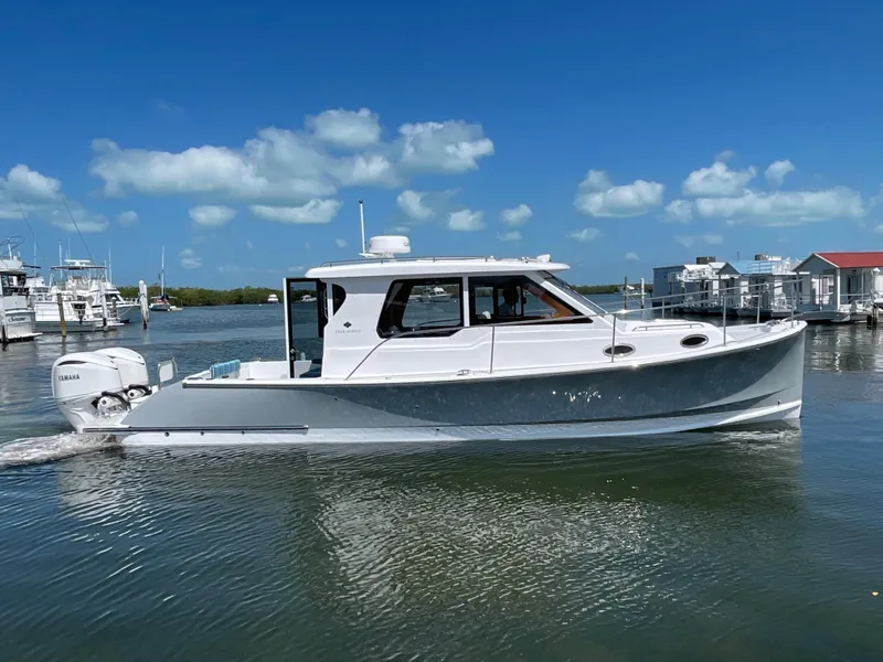 Slide: The Image of 2025 True North 34 Outboard Express boat on calm water under blue sky. - 3