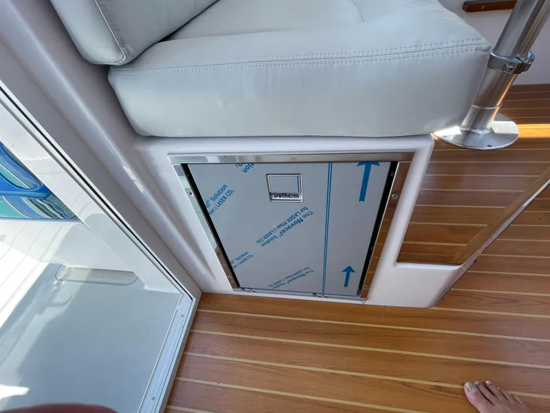 Slide: The Image of Interior of 2025 True North 34 Outboard Express, featuring wooden flooring and seating. - 31