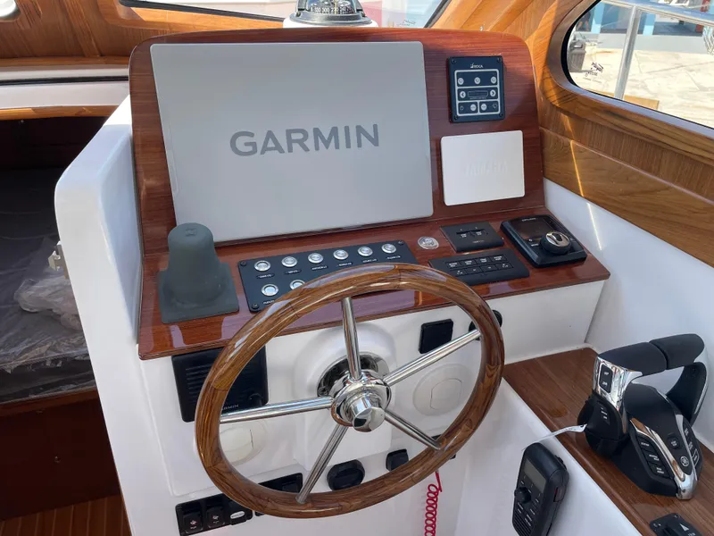 Slide: The Image of Helm of 2025 True North 34 Outboard Express with Garmin navigation system. - 35