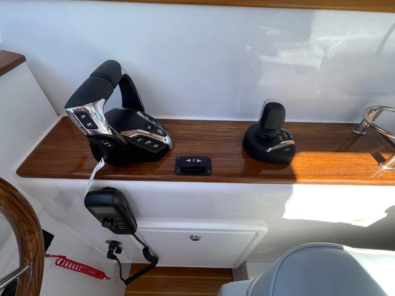 Slide: The Image of Control panel of 2025 True North 34 Outboard Express boat with joystick and throttle. - 36