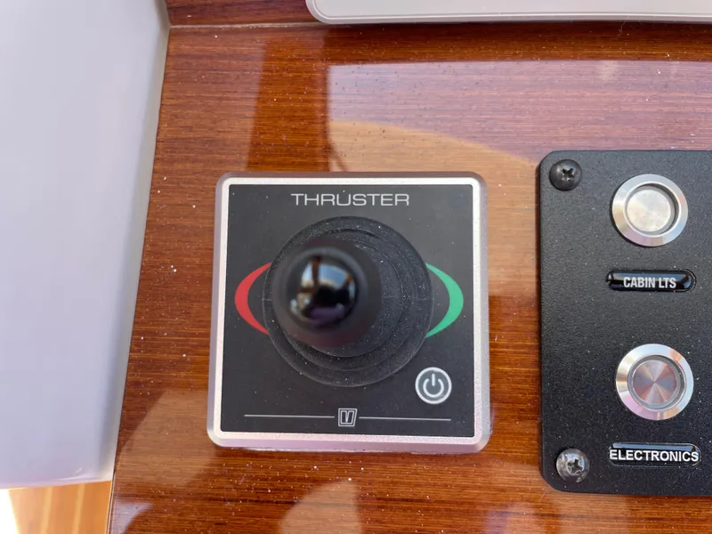 Slide: The Image of Thruster control panel on 2025 True North 34 Outboard Express boat dashboard. - 37
