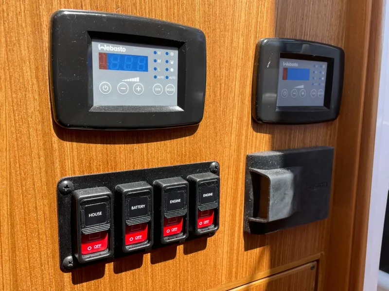 Slide: The Image of Control panel of 2025 True North 34 Outboard Express with digital displays and switches. - 40