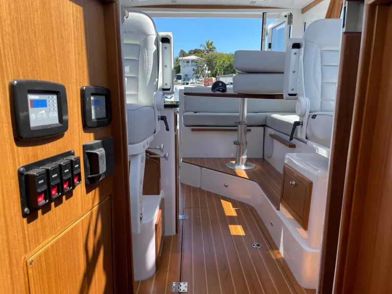 Slide: The Image of Interior of 2025 True North 34 Outboard Express boat with wood flooring and white seating. - 50