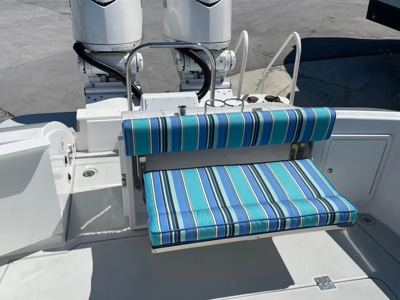 Slide: The Image of 2025 True North 34 Outboard Express boat with striped seating and dual engines. - 51