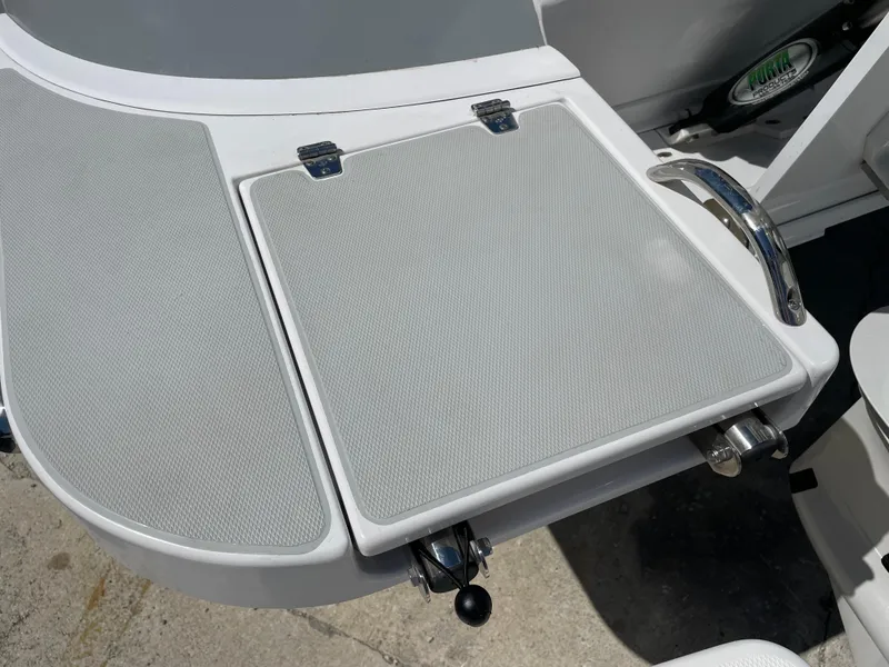 Slide: The Image of True North 34 Outboard Express 2025 boat deck with sleek design and stainless steel handle. - 59