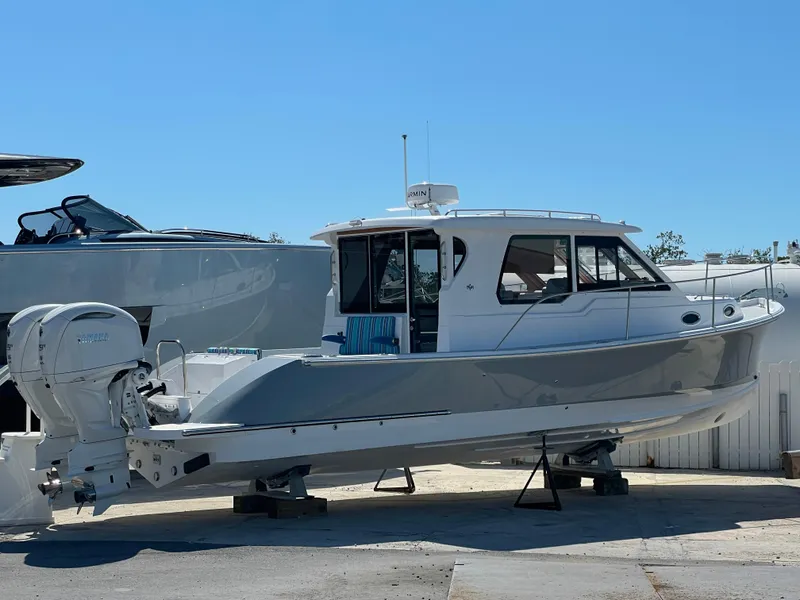 Slide: The Image of 2025 True North 34 Outboard Express boat on display, side view. - 6