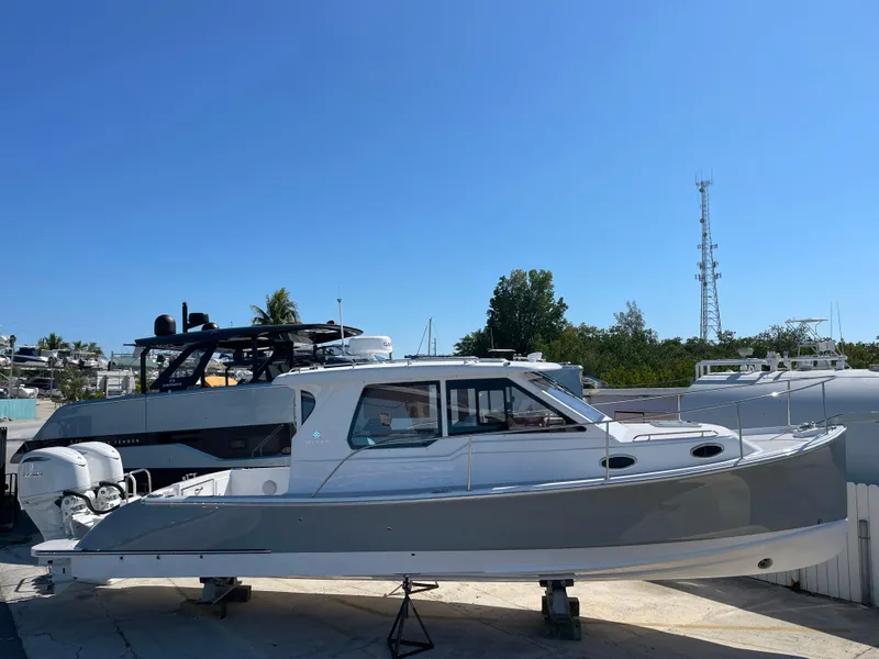Slide: The Image of 2025 True North 34 Outboard Express boat on display under clear blue sky. - 7