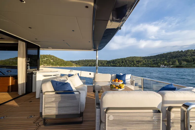 Slide: The Image of Luxurious 2024 Absolute NAVETTA 75 yacht deck with elegant seating and scenic ocean view. - 18
