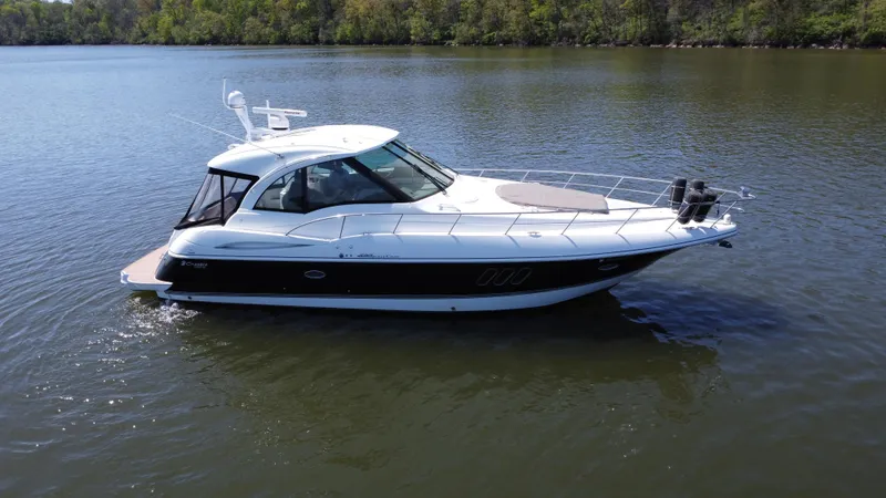 Slide: The Image of 2009 Cruisers Yachts 420 Sports Coupe on calm lake waters. - 12