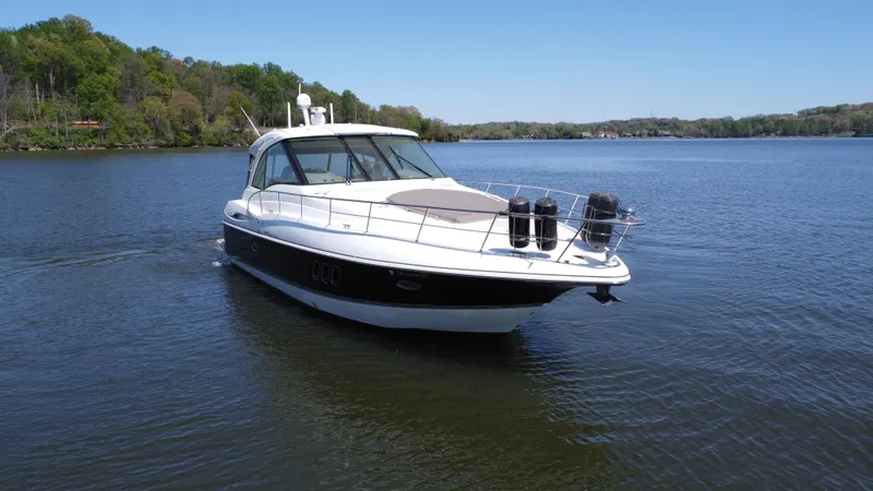 Slide: The Image of 2009 Cruisers Yachts 420 Sports Coupe on a serene lake. - 13