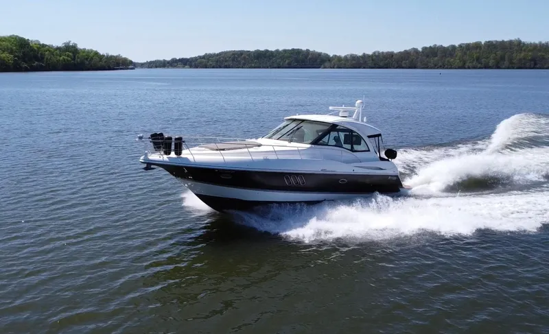 Slide: The Image of 2009 Cruisers Yachts 420 Sports Coupe cruising on a serene lake. - 2