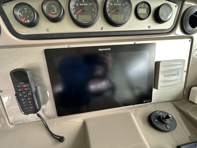 Slide: The Image of 2009 Cruisers Yachts 420 Sports Coupe dashboard with Raymarine display and Garmin device. - 25