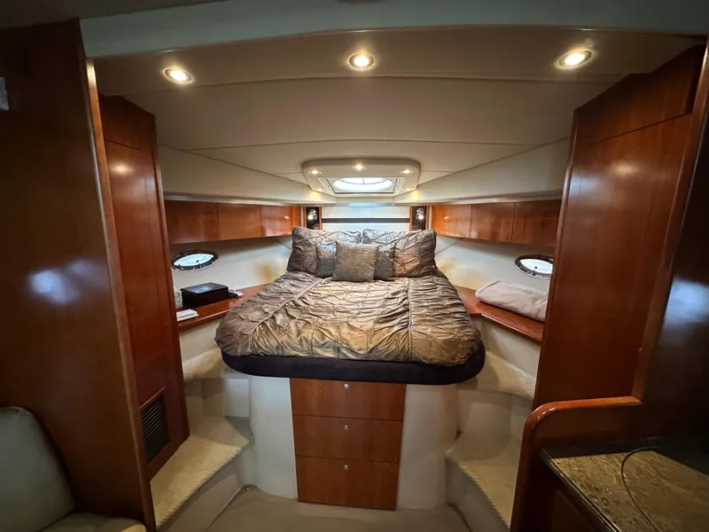 Slide: The Image of Luxurious cabin interior of 2009 Cruisers Yachts 420 Sports Coupe with cozy bed and wood finish. - 28