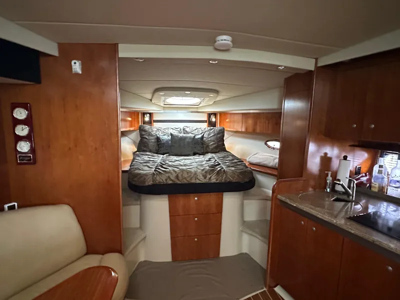 Slide: The Image of Interior of 2009 Cruisers Yachts 420 Sports Coupe with cozy bed and wooden cabinetry. - 38