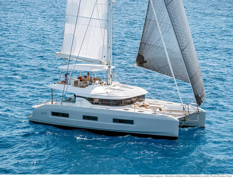 Slide: The Image of 2025 Lagoon 55 catamaran sailing on clear blue ocean waters. - 11