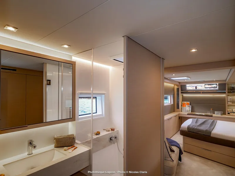 Slide: The Image of Luxurious interior of 2025 Lagoon 55 yacht featuring modern bedroom and bathroom design. - 21