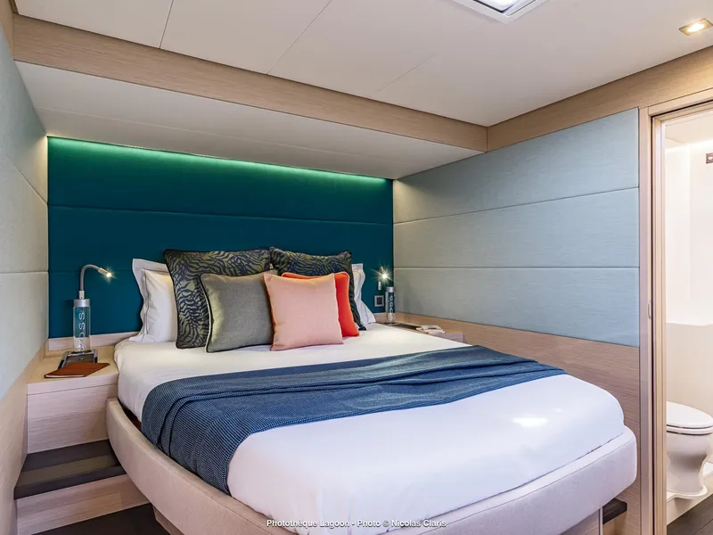 Slide: The Image of Luxurious bedroom interior of 2025 Lagoon 55 yacht with modern design and cozy bedding. - 24