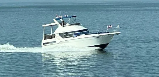 Slide: The Image of 1993 Carver 350 Aft Cabin cruising on calm waters. - 1