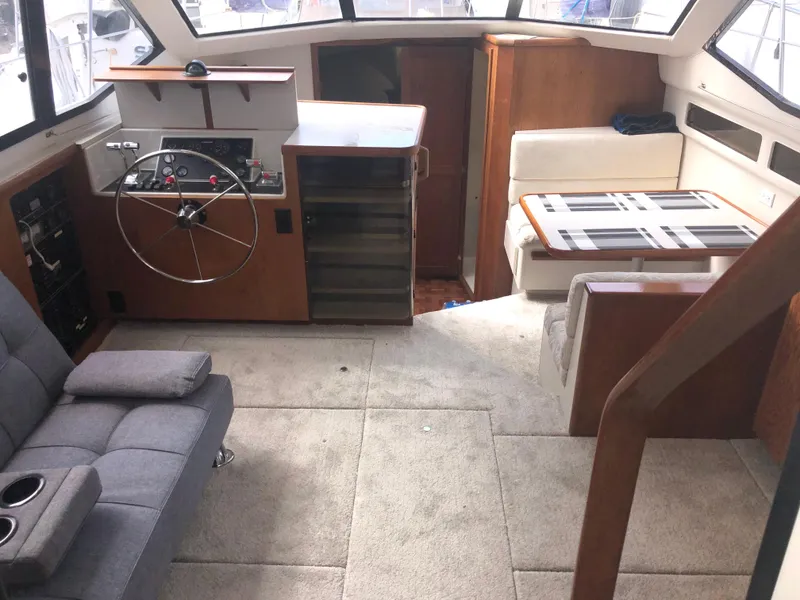 Slide: The Image of Interior of 1993 Carver 350 Aft Cabin with helm, seating, and dining area. - 11