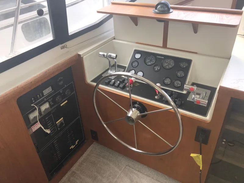 Slide: The Image of 1993 Carver 350 Aft Cabin helm with steering wheel, control panel, and gauges. - 16